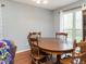 Dining room with hardwood flooring features a wooden table set beneath a modern light fixture at 1850 Crissy Ln, Graham, NC 27253