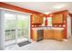 Bright kitchen with sliding glass doors that lead to a wooden deck and stainless steel appliances at 1850 Crissy Ln, Graham, NC 27253