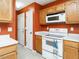 Charming kitchen with white appliances and neutral countertops and flooring at 1850 Crissy Ln, Graham, NC 27253
