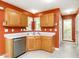 Cozy kitchen with ample countertop space, stainless steel dishwasher and neutral toned tile flooring at 1850 Crissy Ln, Graham, NC 27253