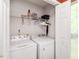 Laundry room featuring side-by-side washer and dryer with wire shelving and natural light at 1850 Crissy Ln, Graham, NC 27253