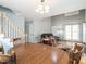 Open-concept living room with staircase and dining table set, with hardwood flooring and plenty of natural light at 1850 Crissy Ln, Graham, NC 27253