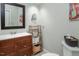 Bathroom featuring a dark wood vanity, framed mirror and a decorative storage shelf at 200 W Woodcroft Pkwy # 45C, Durham, NC 27713