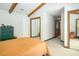 Bedroom featuring exposed beams, carpet flooring, and mirrored closet doors at 200 W Woodcroft Pkwy # 45C, Durham, NC 27713