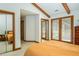 Bedroom with exposed beams, private balcony, and a view into another bedroom at 200 W Woodcroft Pkwy # 45C, Durham, NC 27713