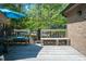 Decking has outdoor seating with a blue umbrella and a natural treeline view at 200 W Woodcroft Pkwy # 45C, Durham, NC 27713
