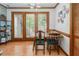 Bright dining area with wood accents, a chandelier and view to an outdoor balcony at 200 W Woodcroft Pkwy # 45C, Durham, NC 27713