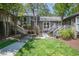 Charming brick townhouse with landscaped yard, sidewalk, and inviting entrance stairs at 200 W Woodcroft Pkwy # 45C, Durham, NC 27713