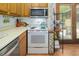 Cozy kitchen featuring white appliances, tile backsplash, and ample countertop space at 200 W Woodcroft Pkwy # 45C, Durham, NC 27713