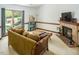 Inviting living room with cozy fireplace and ample natural light from large windows at 200 W Woodcroft Pkwy # 45C, Durham, NC 27713