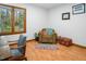 Sitting area has a comfortable chair, throw pillows, and bright natural light at 200 W Woodcroft Pkwy # 45C, Durham, NC 27713