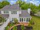 Aerial view of backyard with manicured beds, a white fence, a patio, and the home's exterior at 201 Lakewater Dr, Cary, NC 27511