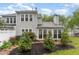 Backyard with manicured beds, a white fence, a patio, and partial views of the home's exterior at 201 Lakewater Dr, Cary, NC 27511