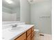 Bright bathroom featuring a vanity with cabinets, a sink, and a shower-tub combo at 201 Lakewater Dr, Cary, NC 27511