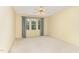 Clean, empty bedroom featuring a ceiling fan, large window with curtains, and hardwood flooring at 201 Lakewater Dr, Cary, NC 27511