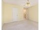 Bright bedroom featuring a ceiling fan, hardwood flooring, and two entryways at 201 Lakewater Dr, Cary, NC 27511