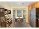 Cozy breakfast nook with a bay window, stainless fridge, and adjacent wooden hutch for storage at 201 Lakewater Dr, Cary, NC 27511