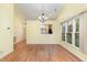 Open dining room with natural light, wooden floors, and a view to the kitchen at 201 Lakewater Dr, Cary, NC 27511