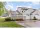 Charming home featuring gray siding, white garage door, and tasteful landscaping on a sunny day at 201 Lakewater Dr, Cary, NC 27511