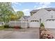 Charming home featuring gray siding, white garage door, and colorful landscaping at 201 Lakewater Dr, Cary, NC 27511