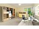 Bright home office with wall-mounted shelving, a work desk, and a comfortable executive chair at 201 Lakewater Dr, Cary, NC 27511