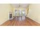 Spacious living room featuring hardwood floors, a fireplace, and large windows for plenty of natural light at 201 Lakewater Dr, Cary, NC 27511