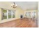 Open living room with large windows, fireplace, and hardwood flooring at 201 Lakewater Dr, Cary, NC 27511