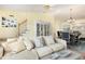 Bright living room with comfortable seating, staircase, and dining area at 201 Lakewater Dr, Cary, NC 27511