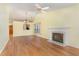 Open living area with fireplace and hardwood floors, seamlessly connecting to the dining area at 201 Lakewater Dr, Cary, NC 27511