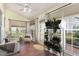 Bright sunroom with lots of windows, indoor plants, and comfortable seating at 201 Lakewater Dr, Cary, NC 27511