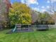 Large backyard with a playground set, trampoline, and swing set for outdoor fun at 204 Oxford Mill Ct, Cary, NC 27518