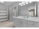 Bathroom with carpet and tile flooring, white vanity and door to an adjacent lavatory at 204 Oxford Mill Ct, Cary, NC 27518