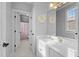 Bright bathroom featuring a white vanity with a large mirror and adjacent lavatory at 204 Oxford Mill Ct, Cary, NC 27518