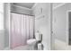 The bathroom has a toilet, a tub with shower curtain, and a window at 204 Oxford Mill Ct, Cary, NC 27518