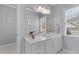 The bathroom has a white vanity with drawers and cabinets, and a large mirror at 204 Oxford Mill Ct, Cary, NC 27518