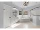 This primary bathroom features a tub, glass shower, and dual windows for natural light at 204 Oxford Mill Ct, Cary, NC 27518