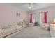 This bedroom has pink accents, a ceiling fan, and 2 windows for natural light at 204 Oxford Mill Ct, Cary, NC 27518