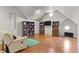 Spacious bonus room with hardwood floors, built-in bookshelves, and a cozy seating area at 204 Oxford Mill Ct, Cary, NC 27518