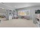 Spacious bonus room with carpet floors and multiple built-in bookcases at 204 Oxford Mill Ct, Cary, NC 27518