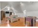 Bonus room with hardwood floors, TV, a foosball table, and natural light at 204 Oxford Mill Ct, Cary, NC 27518