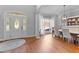 Dining room with hardwood floors, bright lighting, stained-glass front door and large window at 204 Oxford Mill Ct, Cary, NC 27518