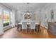 Bright dining room features a hutch, hardwood floors, and a large window at 204 Oxford Mill Ct, Cary, NC 27518