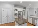 Kitchen featuring stainless steel refrigerator and appliances with white cabinetry and an island at 204 Oxford Mill Ct, Cary, NC 27518