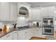 Kitchen featuring granite countertops, tile backsplash, stainless steel oven and white cabinetry at 204 Oxford Mill Ct, Cary, NC 27518