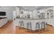 An open-concept kitchen includes an island, bar stool seating, granite countertops and stainless steel appliances at 204 Oxford Mill Ct, Cary, NC 27518