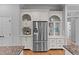Kitchen featuring a stainless steel refrigerator surrounded by built-in white cabinetry at 204 Oxford Mill Ct, Cary, NC 27518