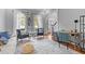 Bright living room with lots of natural light, two chairs, white sofa, and hardwood floors at 204 Oxford Mill Ct, Cary, NC 27518