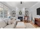 Comfortable living room featuring a fireplace, large windows and built-in shelving at 204 Oxford Mill Ct, Cary, NC 27518