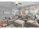 Spacious living room with a large sectional sofa, plenty of pillows, and a view of the backyard at 204 Oxford Mill Ct, Cary, NC 27518