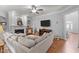 Inviting living room with hardwood floors, built-in shelving, and large television at 204 Oxford Mill Ct, Cary, NC 27518